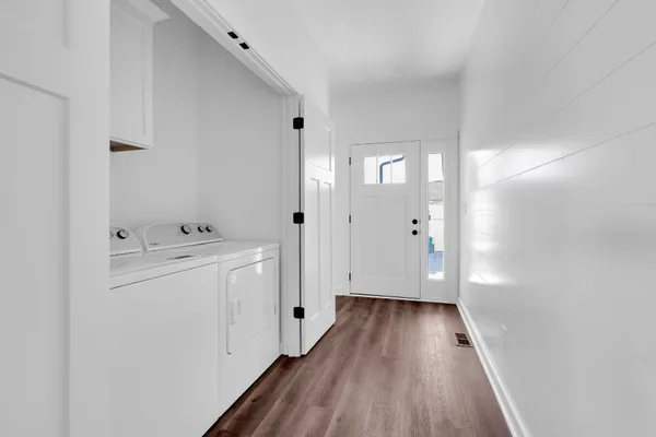 a view of hallway with wooden floor