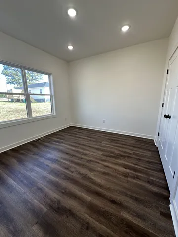 an empty room with wooden floor