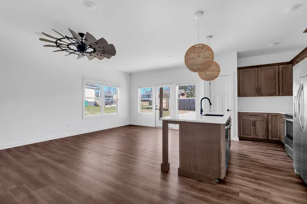 a view of a kitchen counter space a sink and a stove top oven
