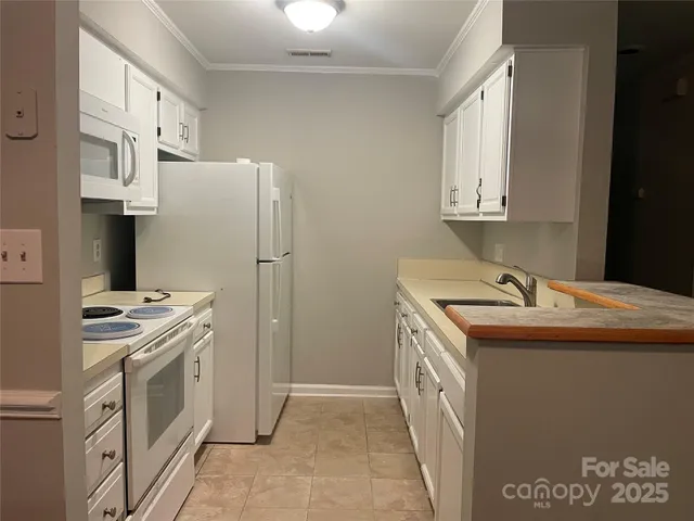 a kitchen that has a sink and a stove