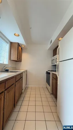 a kitchen with a sink a refrigerator and washer
