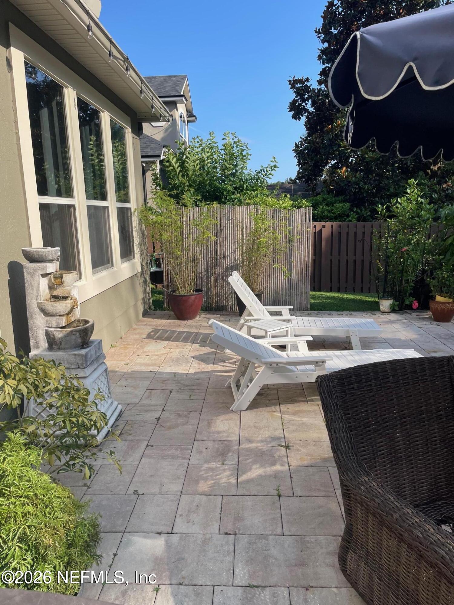 232 South Hampton Club Way St. Augustine, FL 32092 - Photo 36 of 55 a view of a lounge chair in the patio with a fire pit and wooden fence