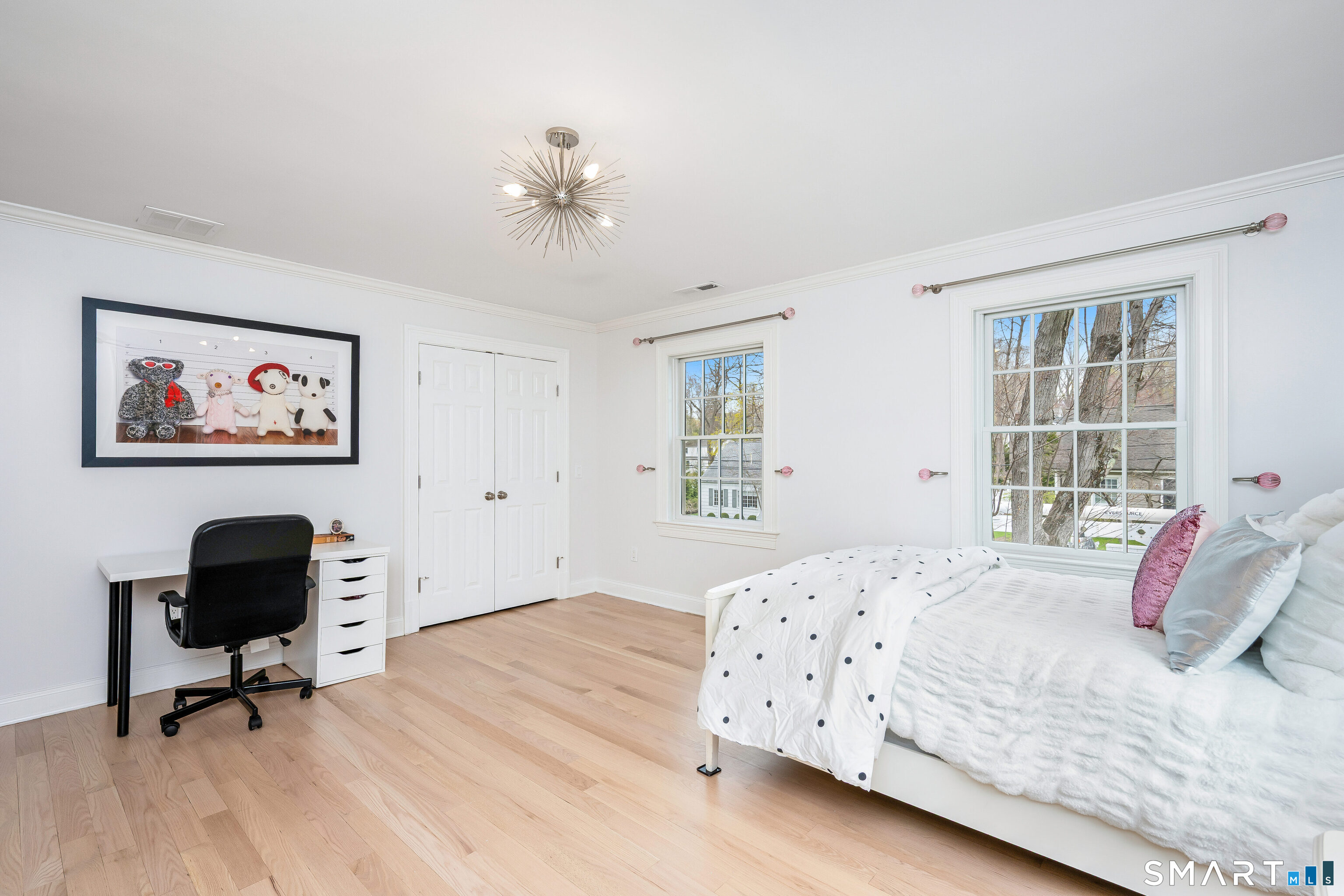 34 Intervale Road Darien, CT 06820 - Photo 19 of 36 a bedroom with a bed and a chandelier