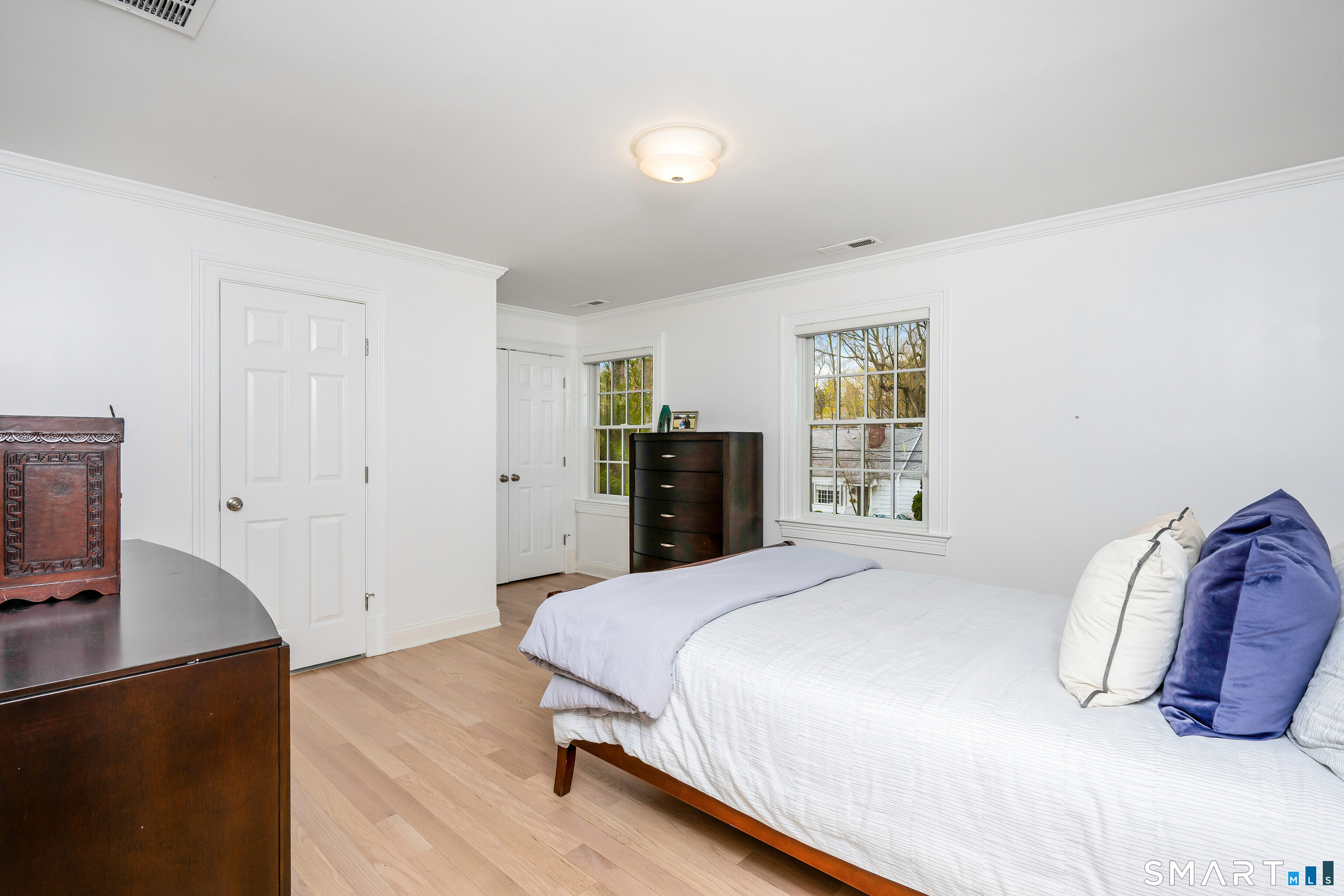 34 Intervale Road Darien, CT 06820 - Photo 20 of 36 a bedroom with a bed and wooden floor