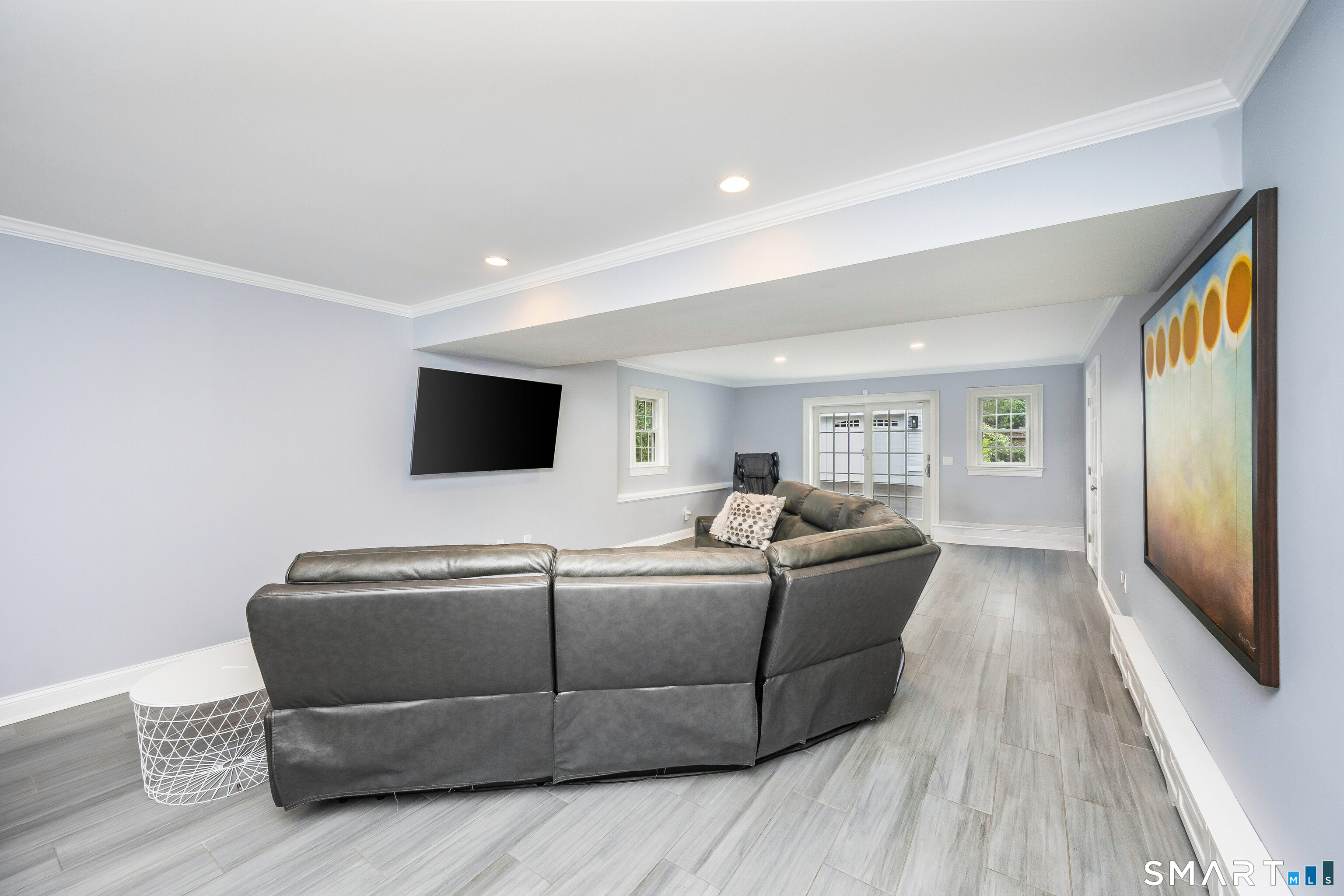 34 Intervale Road Darien, CT 06820 - Photo 24 of 36 a living room with a couch and a flat screen tv