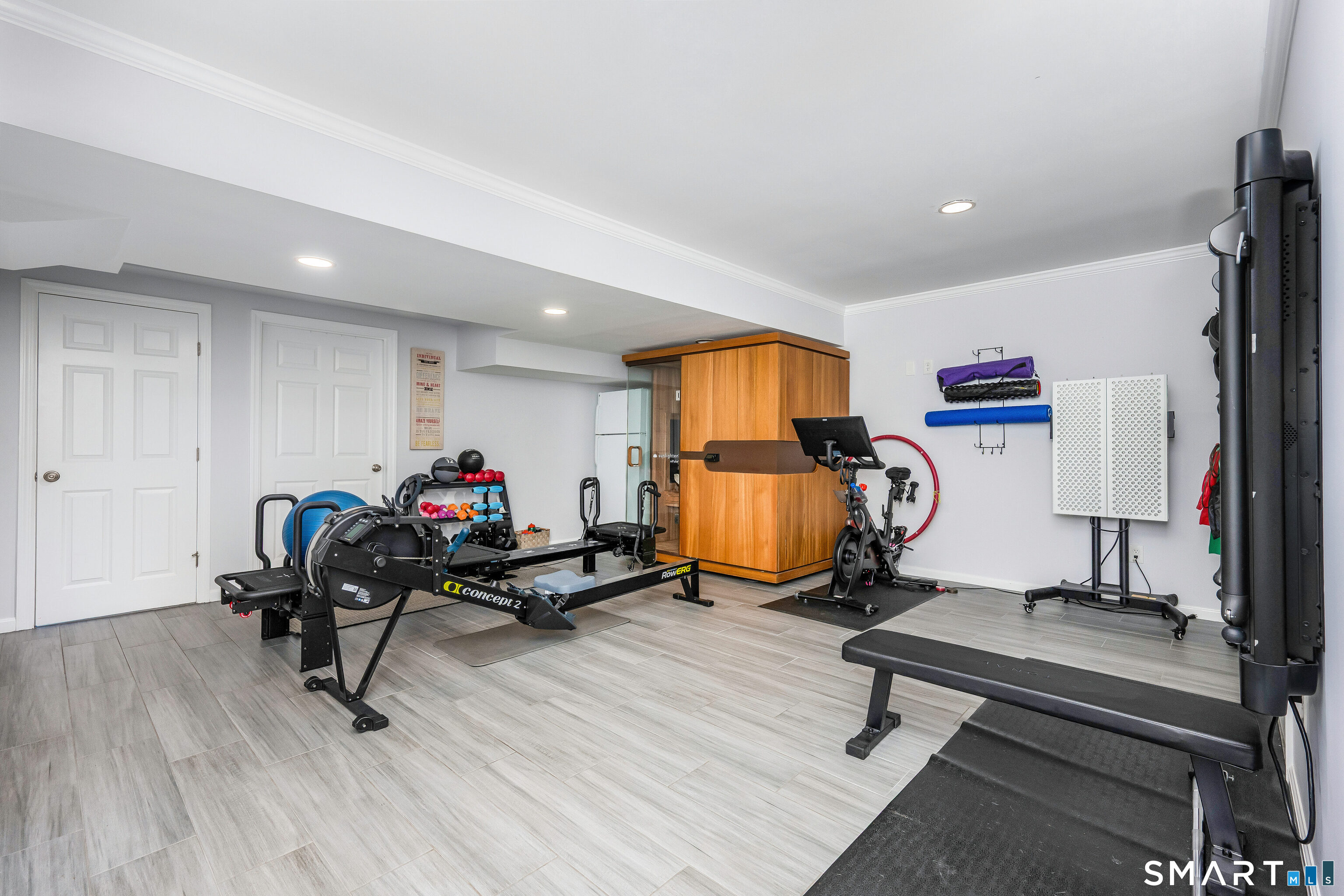 34 Intervale Road Darien, CT 06820 - Photo 25 of 36 a living room with furniture gym equipment and a fireplace