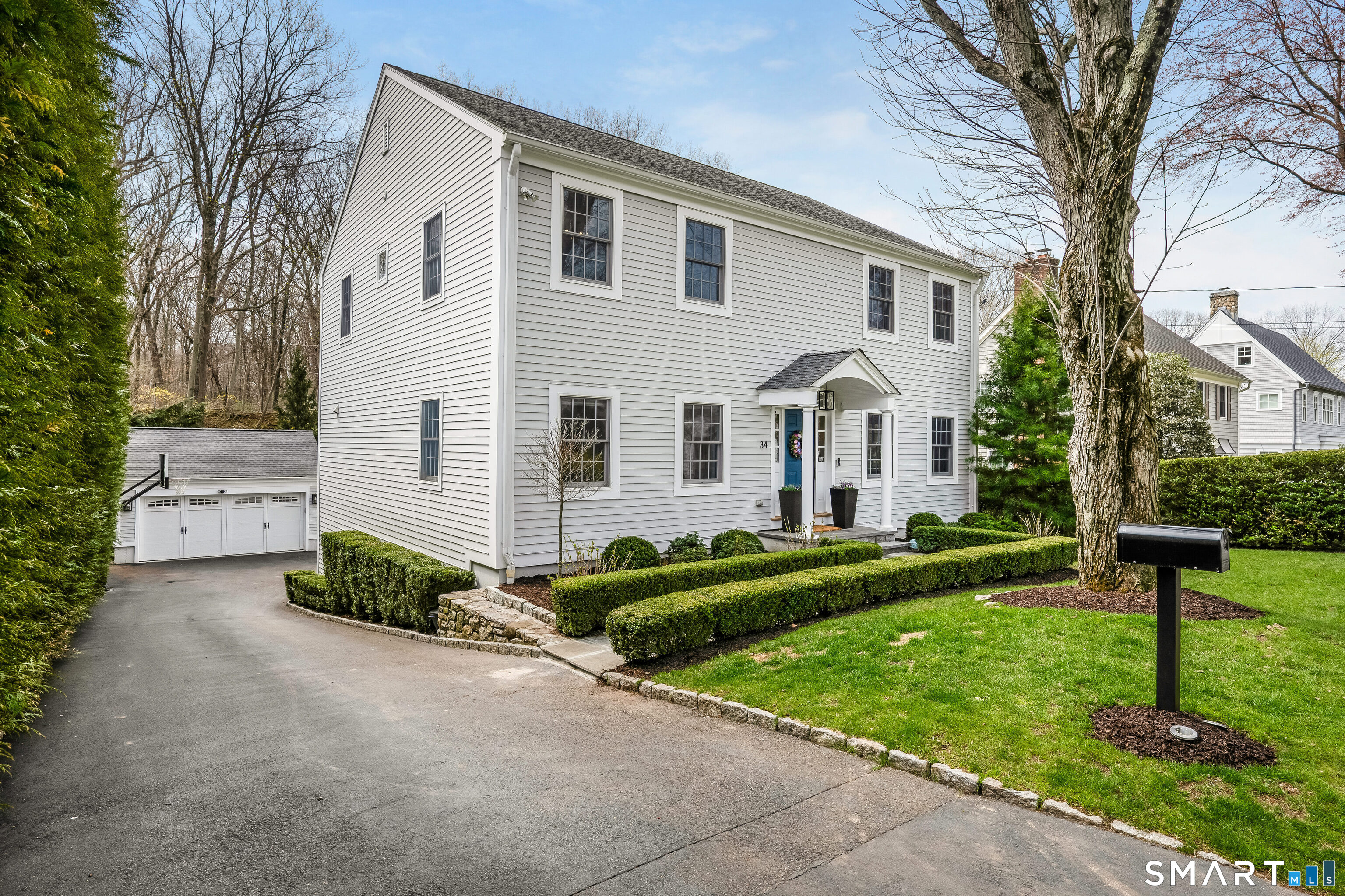 34 Intervale Road Darien, CT 06820 - Photo 32 of 36 a front view of a house with a yard and garage