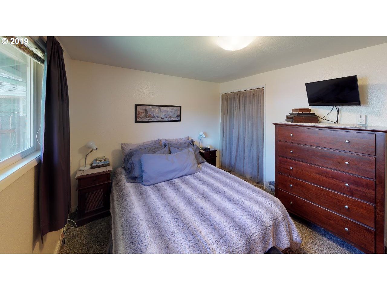 4808 Daisy Street Springfield, OR 97478 - Photo 8 of 20 a bedroom with a bed and a flat screen tv