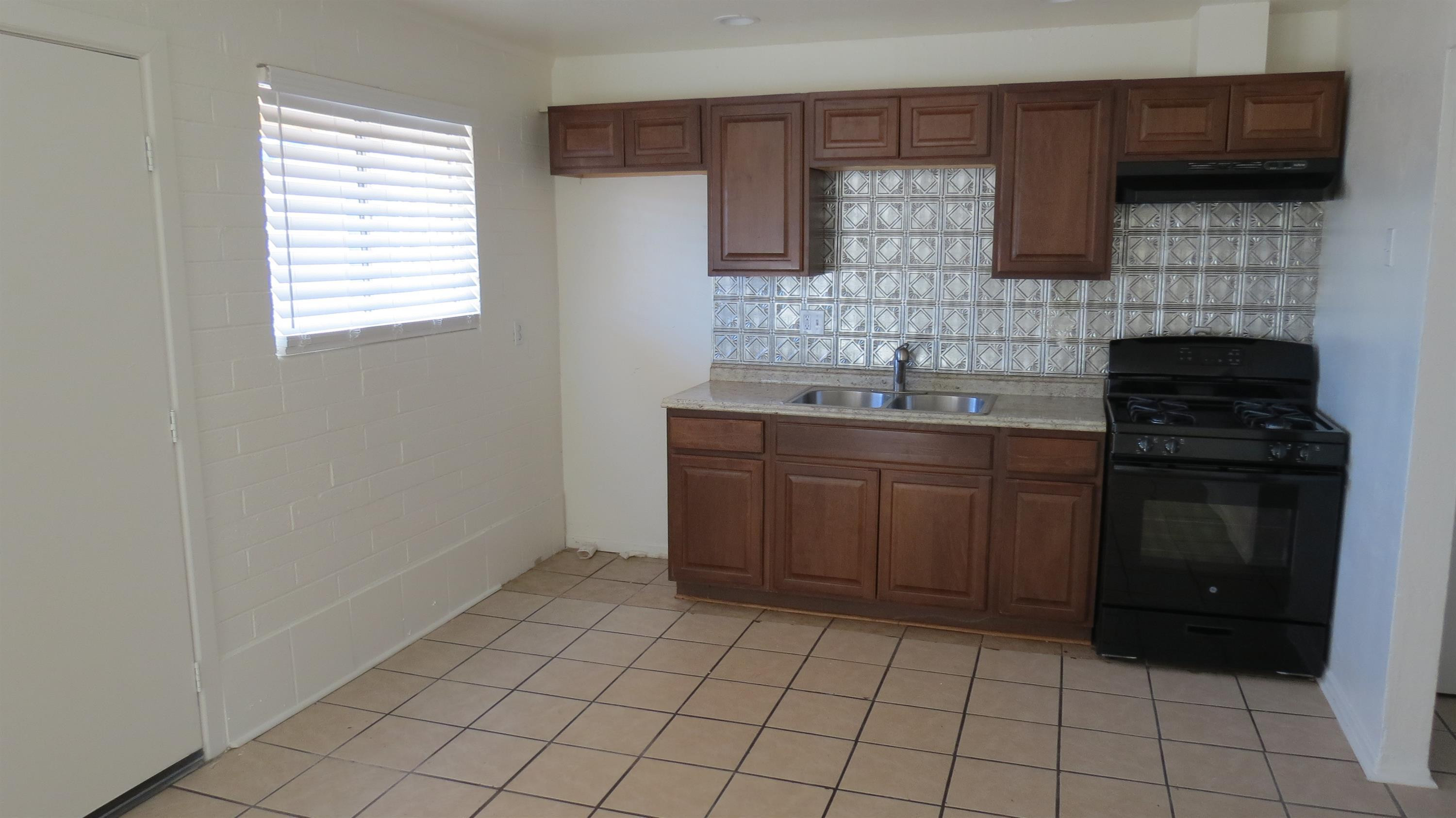 4329 North Longview Avenue, Unit 2 Phoenix, AZ 85014 - Photo 3 of 12 a kitchen with stainless steel appliances a sink stove and cabinets
