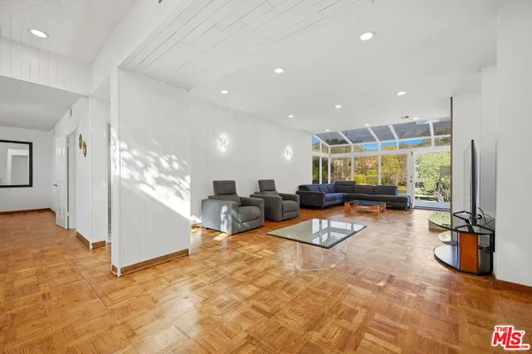 a living room with furniture a ceiling fan and a rug