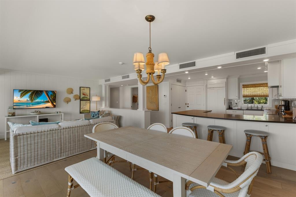 5850 Gasparilla Road, Unit M1&3 Boca Grande, FL 33921 - Photo 16 of 57 a living room with furniture a chandelier and a flat screen tv