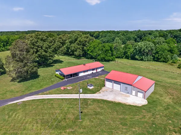an aerial view of a house with yard