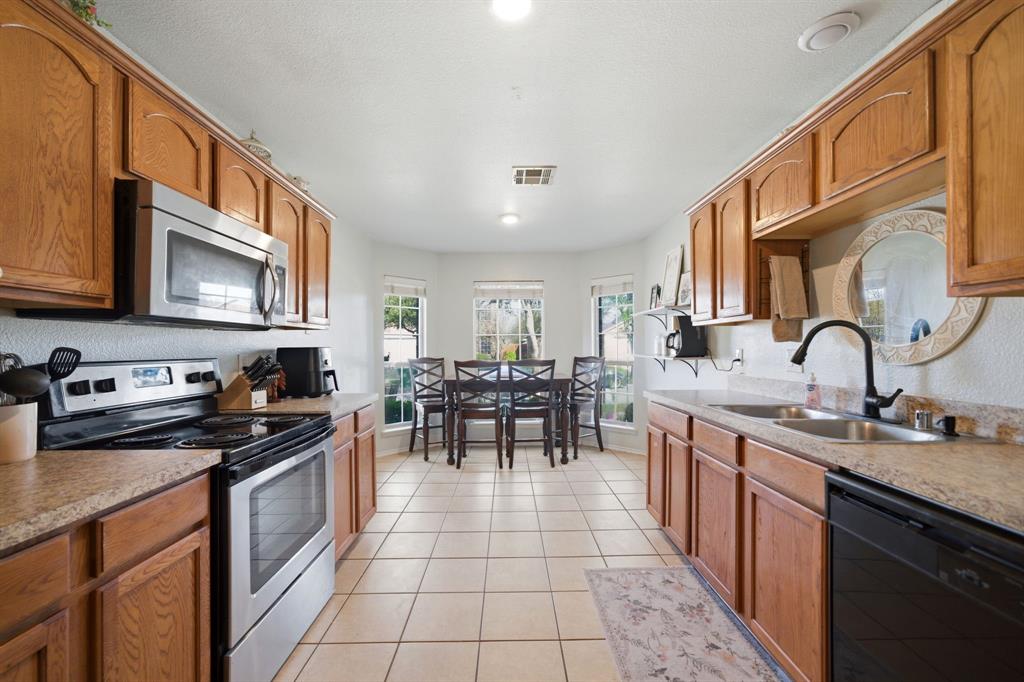 2008 Times Road Heartland, TX 75126 - Photo 11 of 28 a kitchen with appliances a sink and cabinets