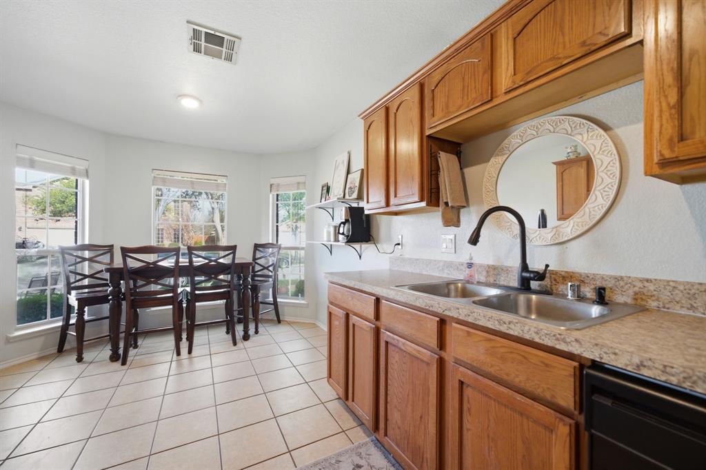 2008 Times Road Heartland, TX 75126 - Photo 12 of 28 a kitchen with kitchen island granite countertop a sink a counter and chairs