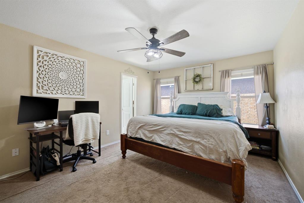 2008 Times Road Heartland, TX 75126 - Photo 16 of 28 a bedroom with a bed and a chandelier