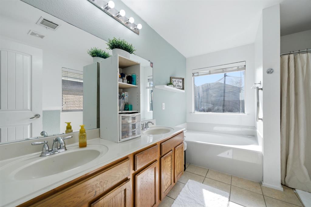 2008 Times Road Heartland, TX 75126 - Photo 18 of 28 a bathroom with a tub sink and mirror
