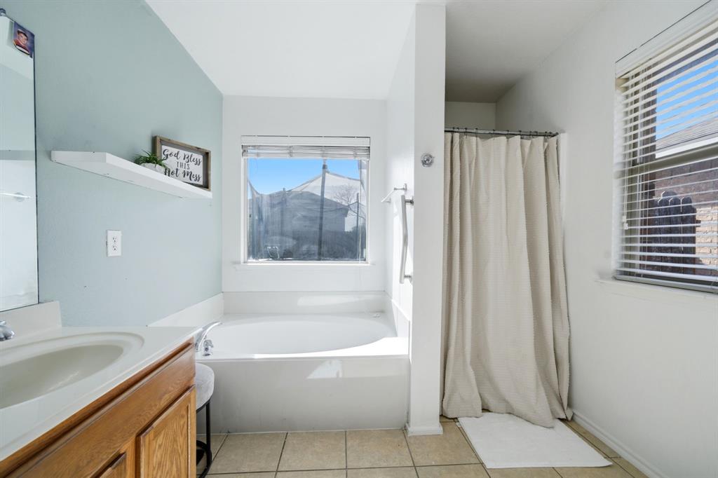 2008 Times Road Heartland, TX 75126 - Photo 19 of 28 a white bath tub sitting next to a white sink