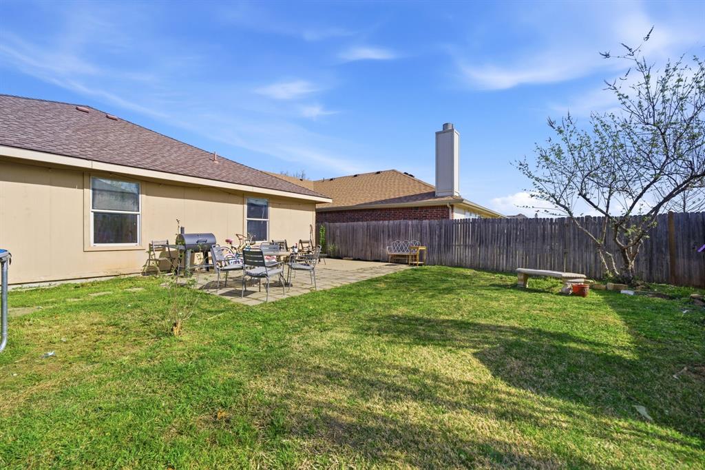 2008 Times Road Heartland, TX 75126 - Photo 26 of 28 a view of a backyard with table and chairs potted plants and wooden fence