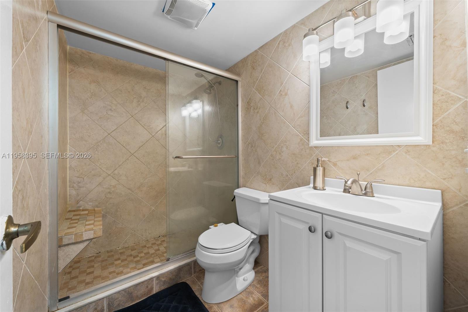 4011 Meridian Avenue, Unit 38 Miami Beach, FL 33140 - Photo 12 of 22 a bathroom with a sink a toilet and shower