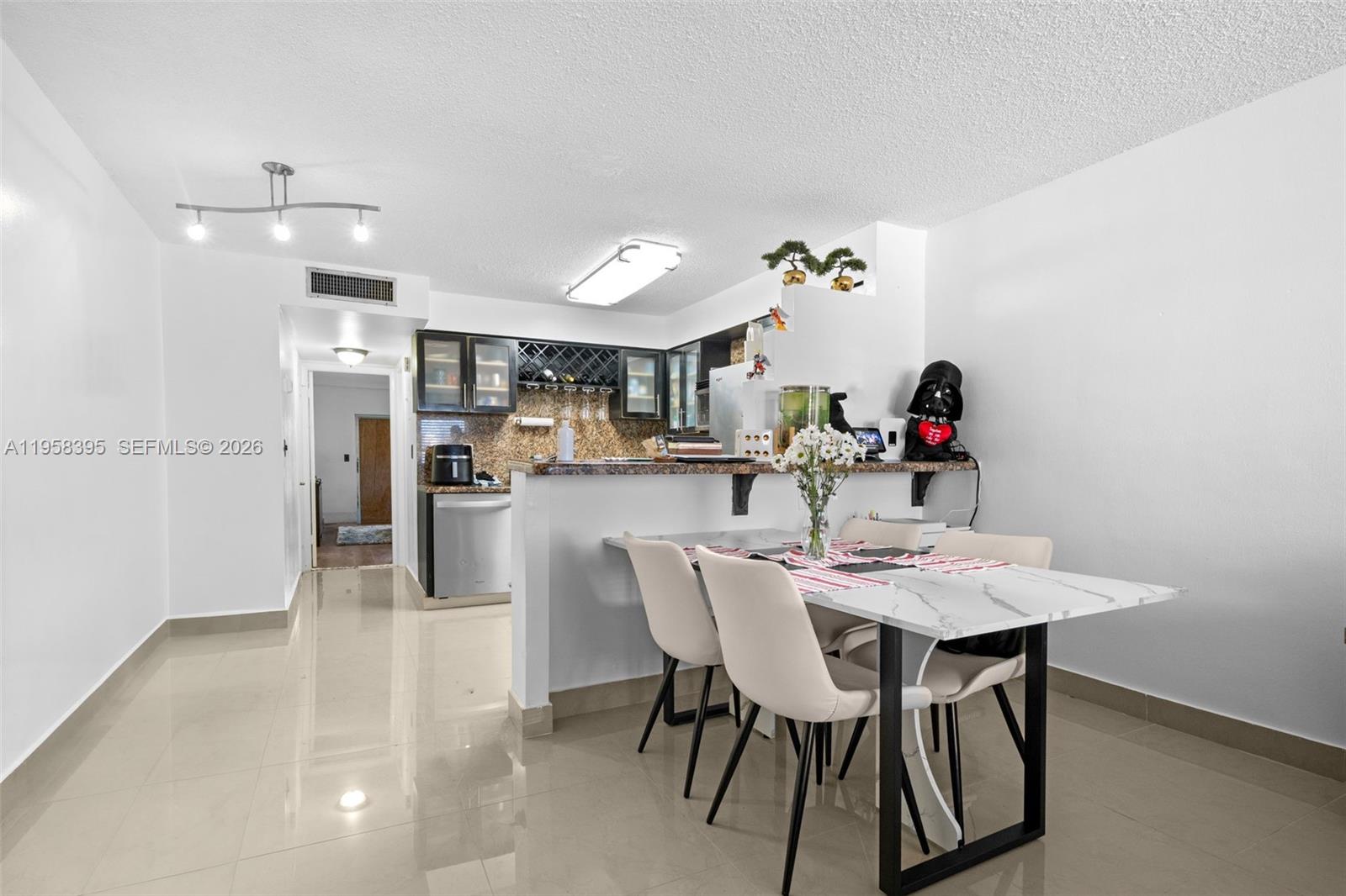 4011 Meridian Avenue, Unit 38 Miami Beach, FL 33140 - Photo 4 of 22 a view of a dining area with furniture and chandelier