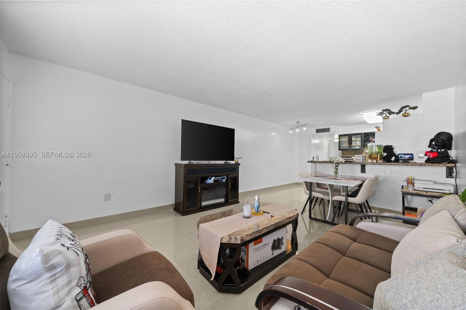 4011 Meridian Avenue, Unit 38 Miami Beach, FL 33140 - Photo 6 of 22 a living room with furniture and a flat screen tv