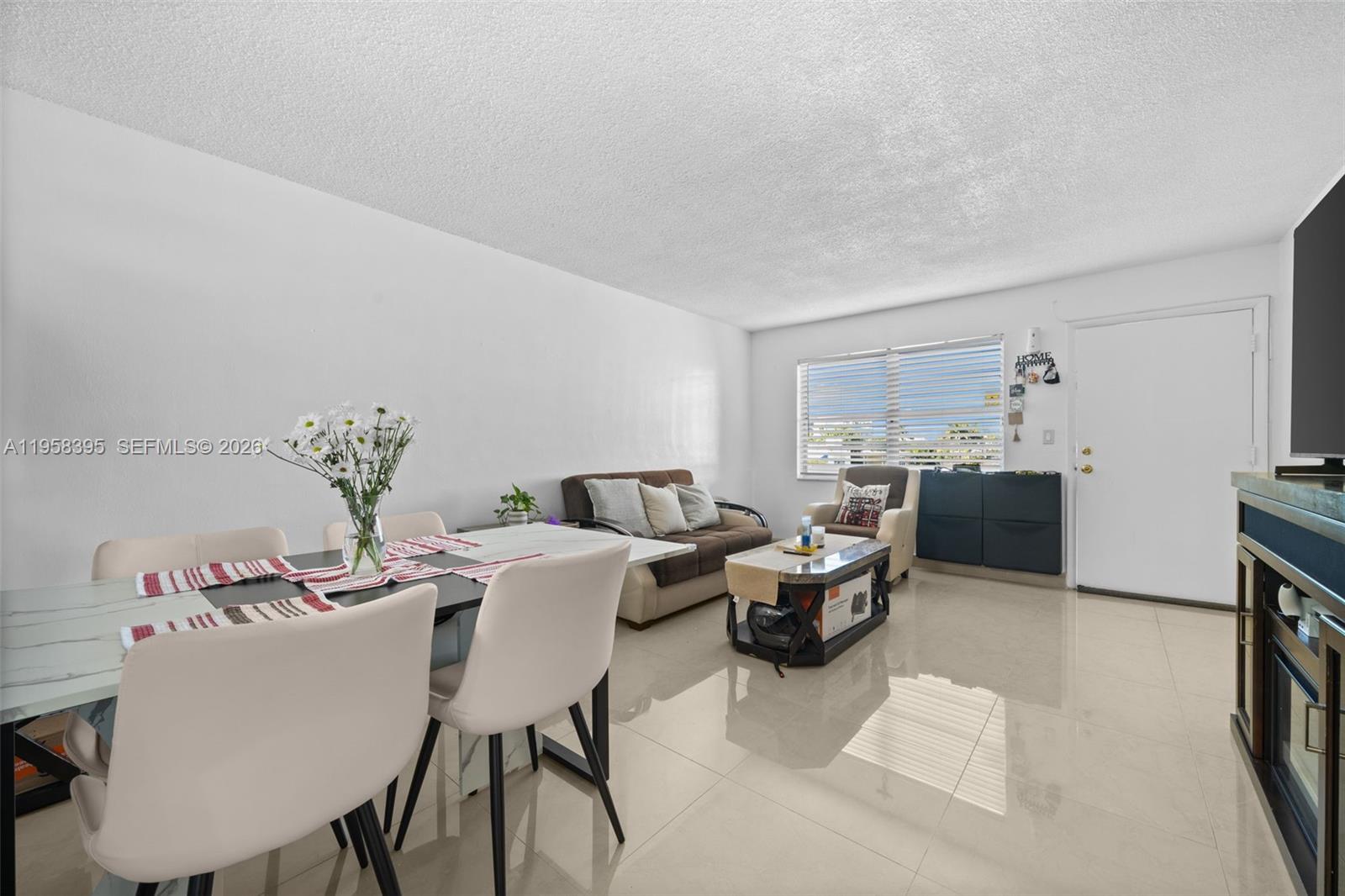 4011 Meridian Avenue, Unit 38 Miami Beach, FL 33140 - Photo 8 of 22 a dining room with furniture and window