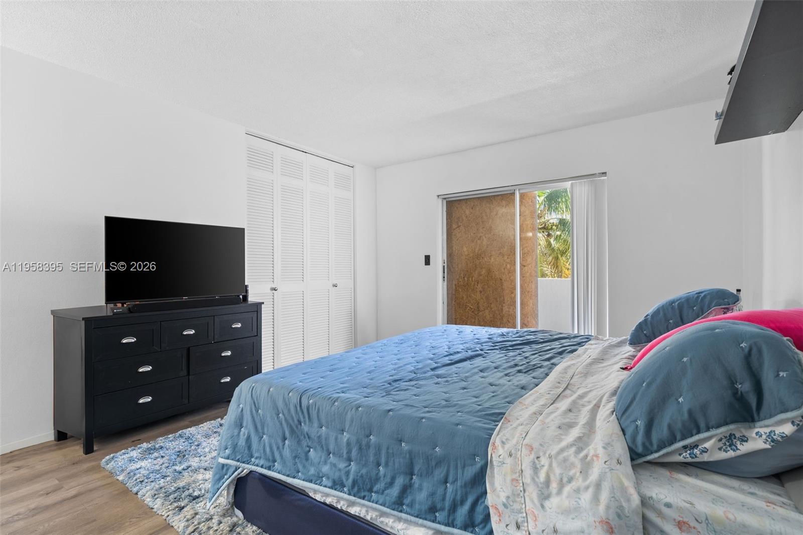 4011 Meridian Avenue, Unit 38 Miami Beach, FL 33140 - Photo 9 of 22 a bedroom with a bed and a television