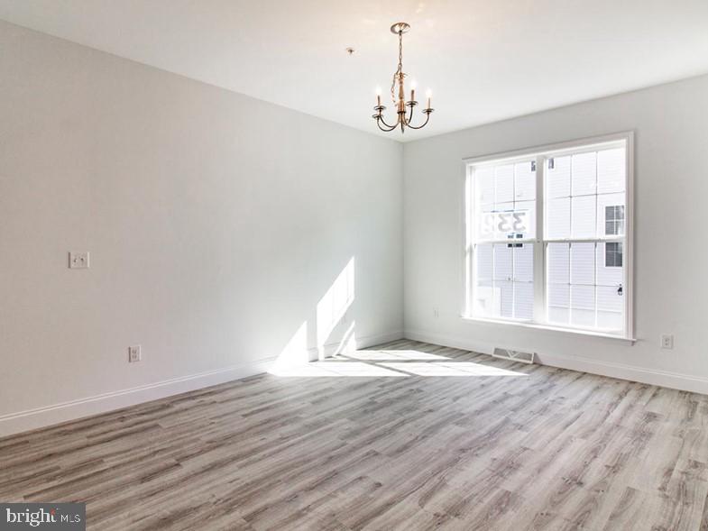 3228 Light Way Mechanicsburg, PA 17055 - Photo 11 of 33 a view of an empty room with wooden floor and a window