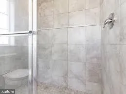 a bathroom with a toilet and a shower