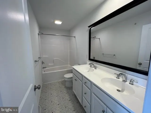 a bathroom with a tub sink toilet and mirror
