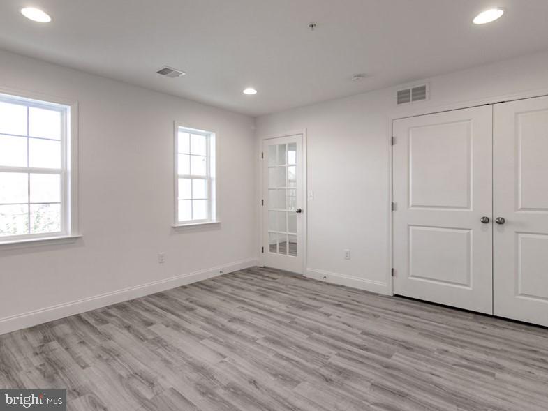 3228 Light Way Mechanicsburg, PA 17055 - Photo 3 of 33 an empty room with wooden floor and windows