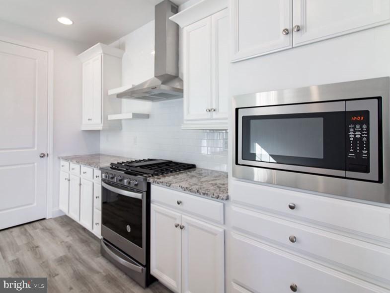3228 Light Way Mechanicsburg, PA 17055 - Photo 9 of 33 a kitchen with stainless steel appliances white cabinets and stove