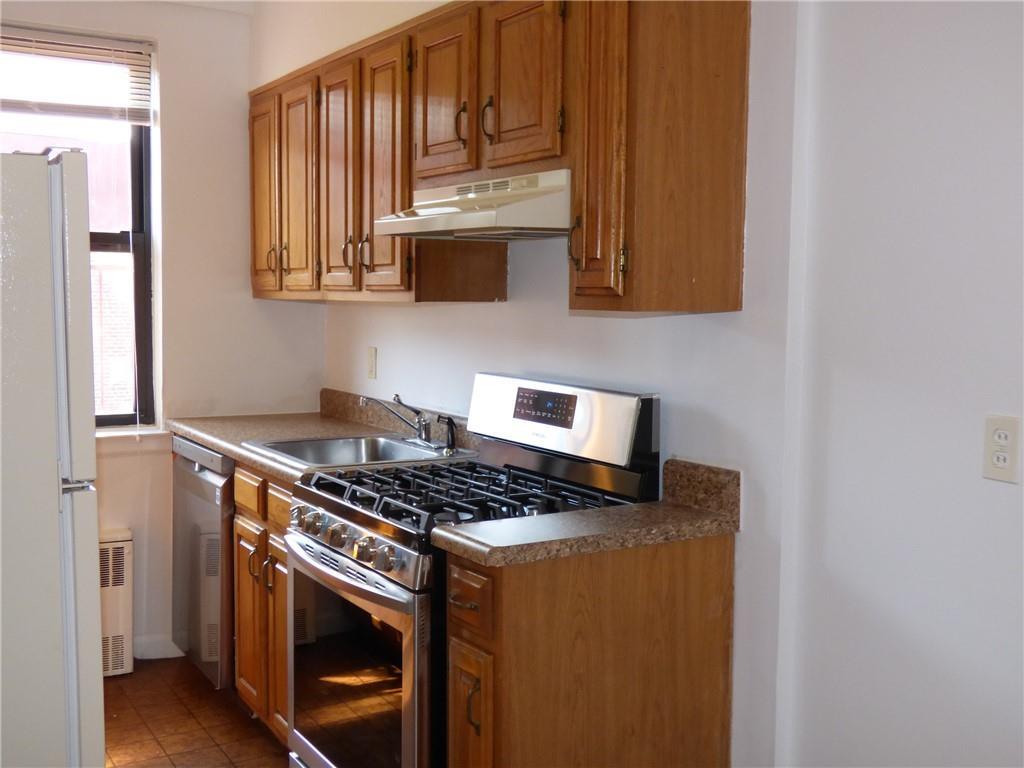 a kitchen with stainless steel appliances granite countertop a stove and a microwave