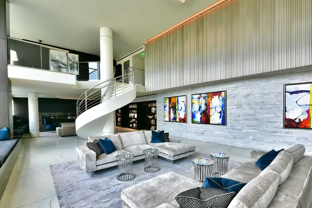 a living room with furniture and stairs