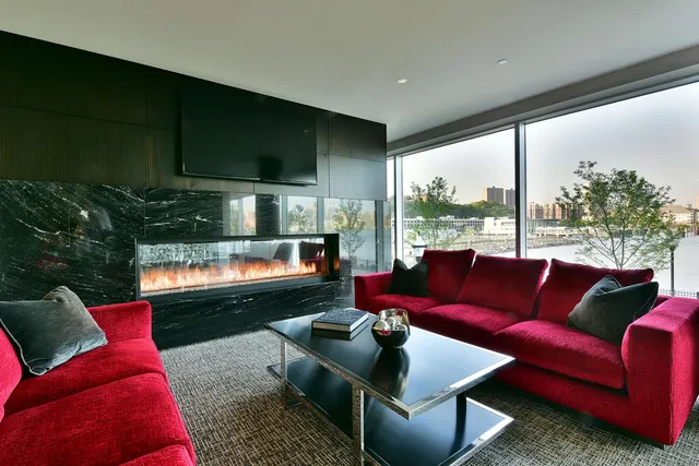 a living room with furniture and a floor to ceiling window