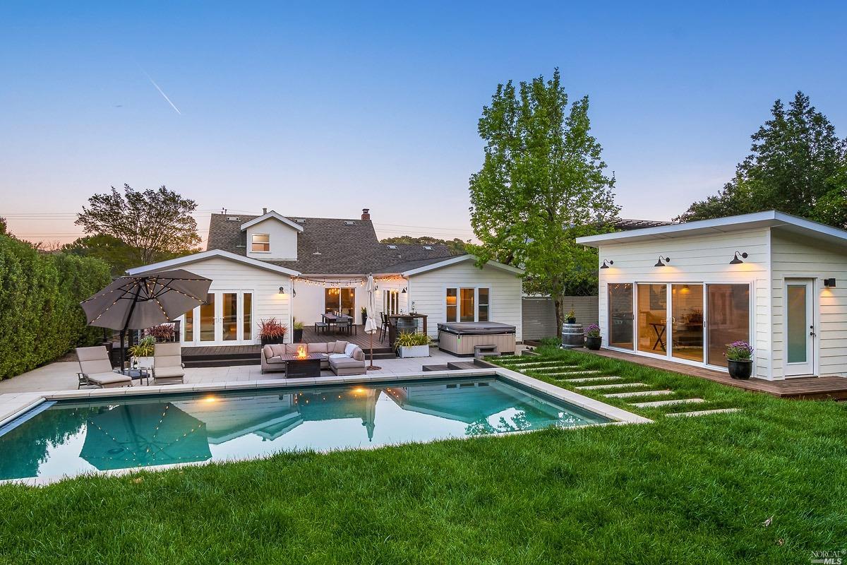 a front view of a house with a yard table and chairs
