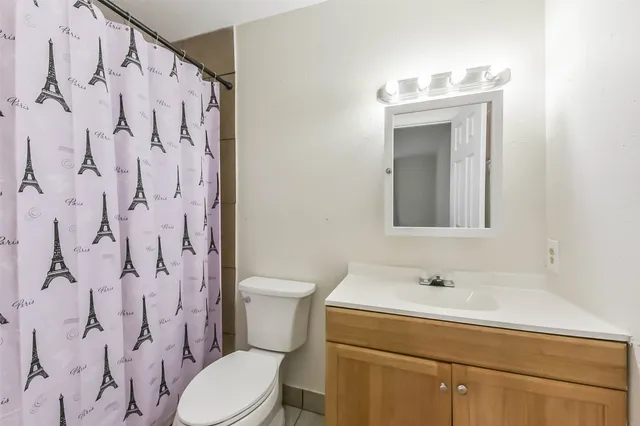 a bathroom with a sink toilet and a mirror