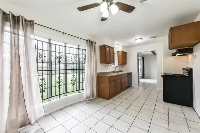 a large white kitchen with a large window