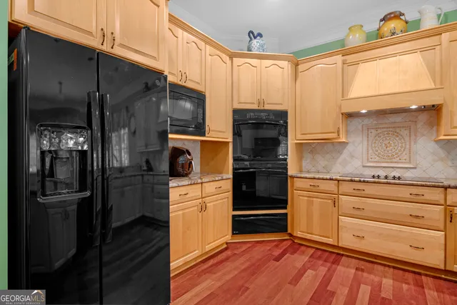 a kitchen with lots of counter top space and wooden floor