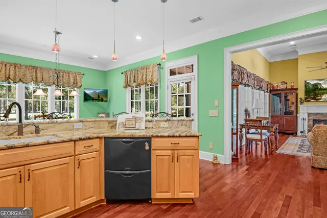 a dining room with furniture window and wooden floor