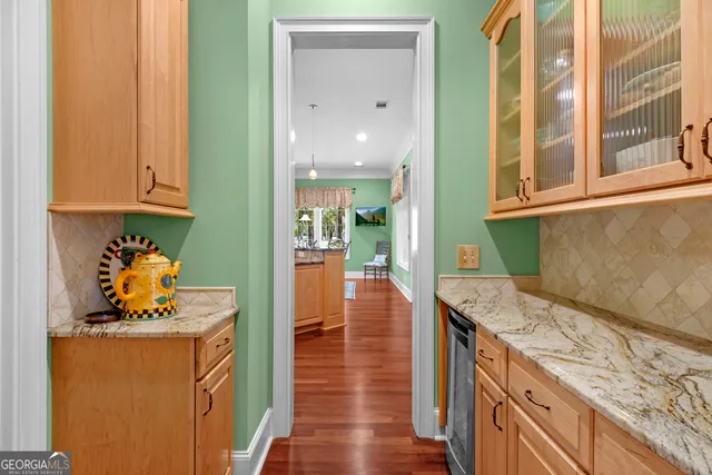 a living room with patio furniture and a floor to ceiling window