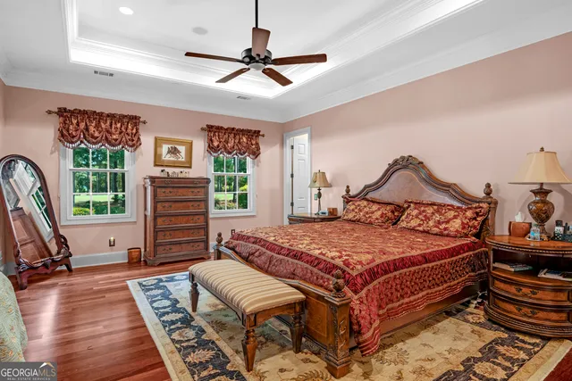 a en suite bathroom with a granite countertop sink and a mirror