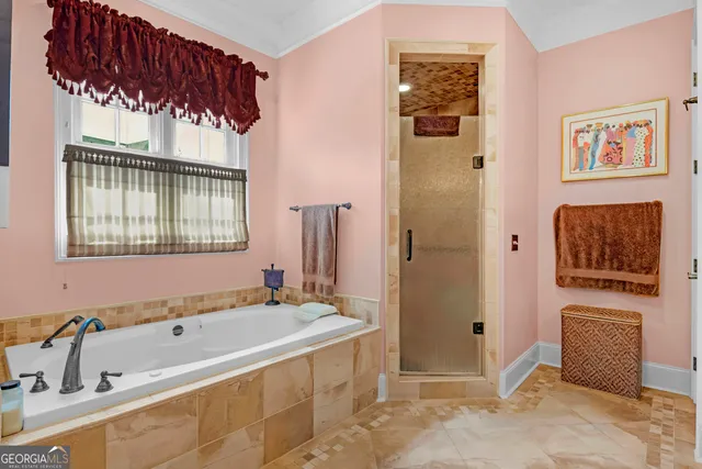 a white toilet sitting next to a white sink and vanity