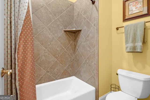 a bedroom with a bed and ceiling fan