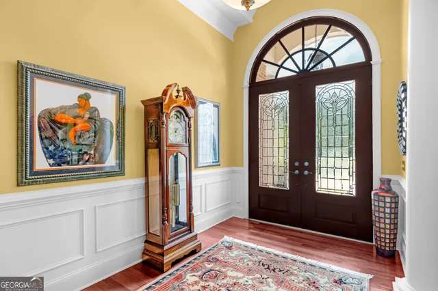 a living room with furniture a rug and a chandelier