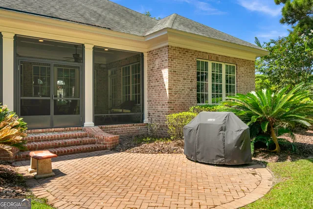an aerial view of a house with a garden and lake view