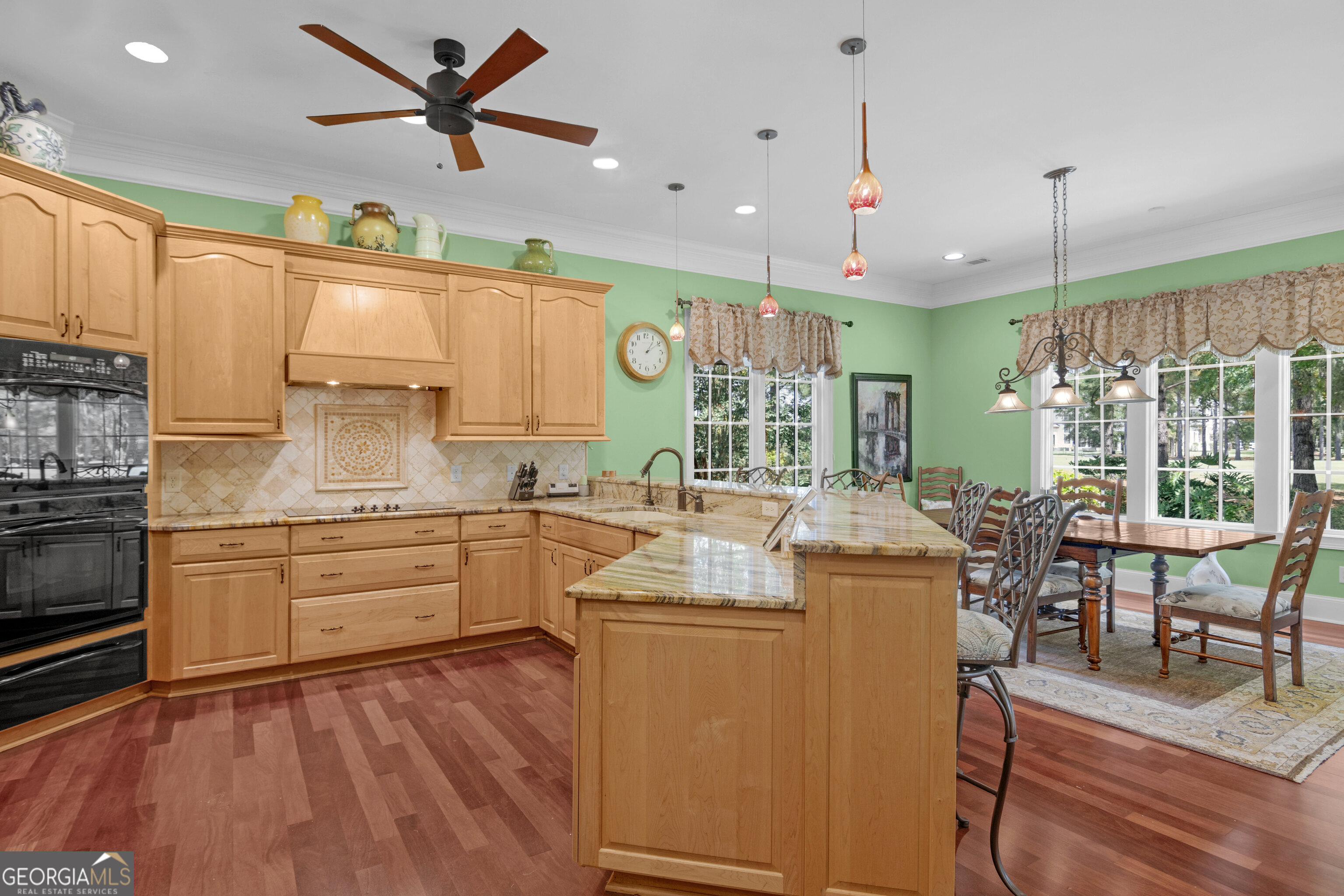 312 Spanton Crescent Pooler, GA 31322 - Photo 10 of 62 a kitchen with kitchen island a large counter space appliances and a window