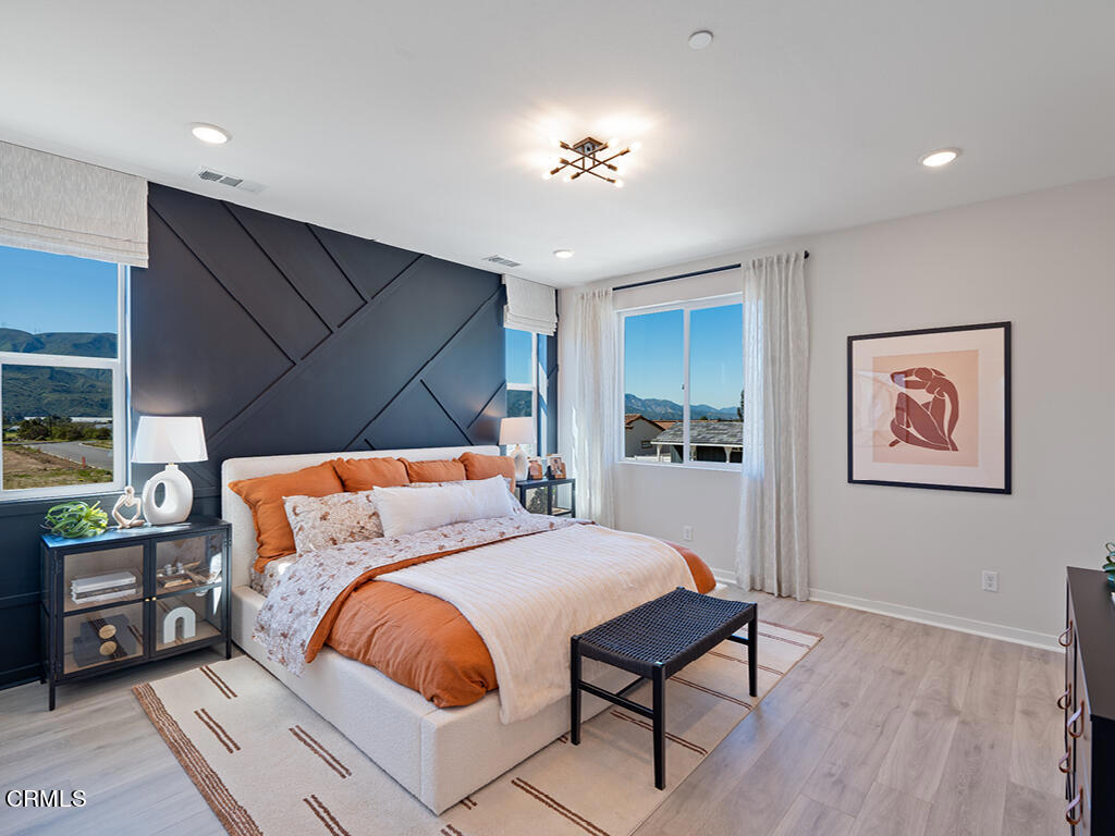 3822 Silvergrass Lane Piru, CA 93040 - Photo 12 of 24 a bedroom with a bed and a chandelier