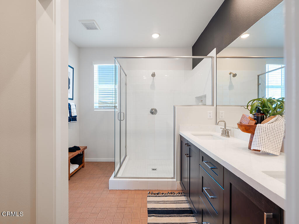3822 Silvergrass Lane Piru, CA 93040 - Photo 17 of 24 a bathroom with a shower sink and mirror