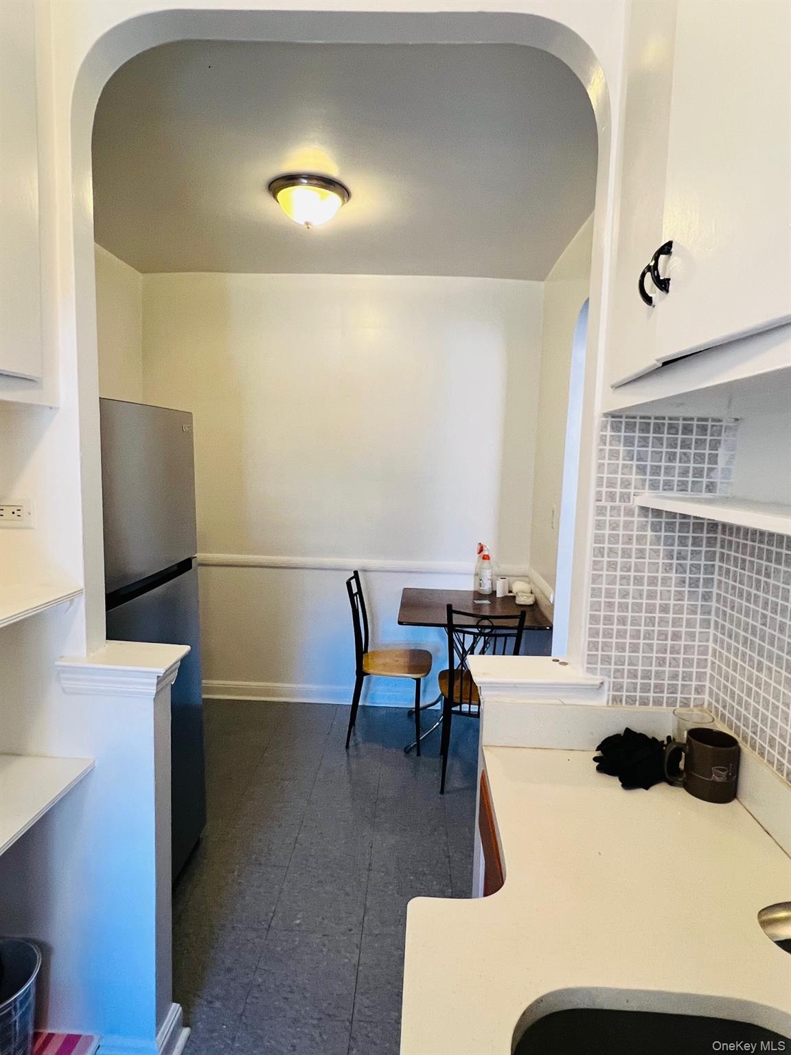 67-35 Yellowstone Boulevard, Unit 7E Queens, NY 11375 - Photo 13 of 16 a living room with furniture and a flat screen tv
